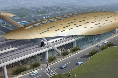 Futuristic train station with a sleek, gold roof and modern architectural design.